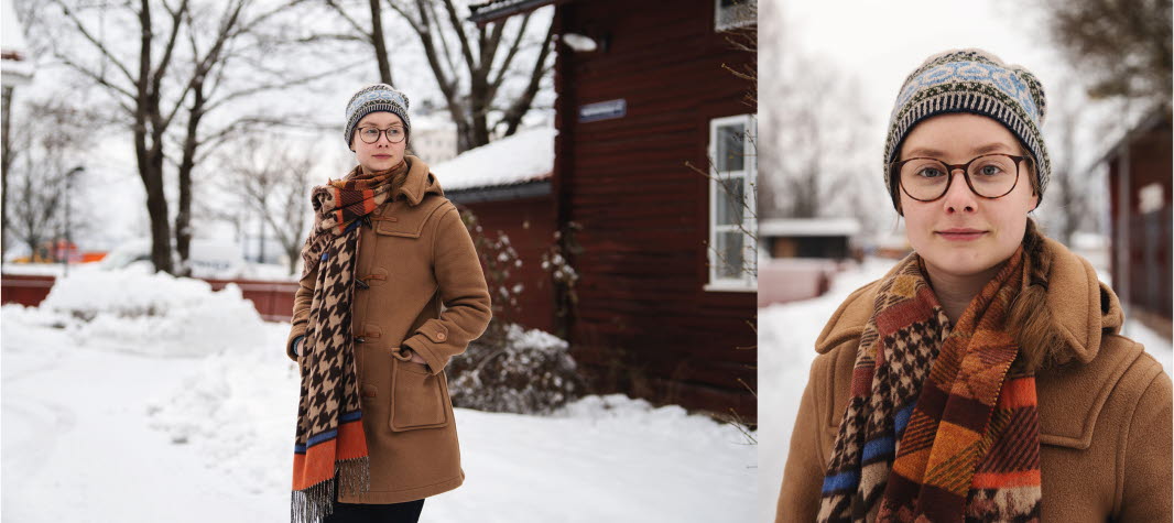 A women with a brown coat standing outside in the snowy winter