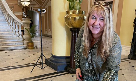 Woman  standing indoors smiling 