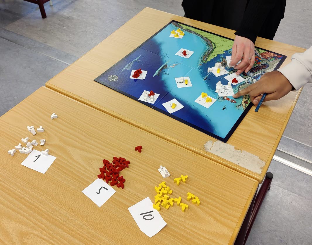 Students playing a board game in a classroom