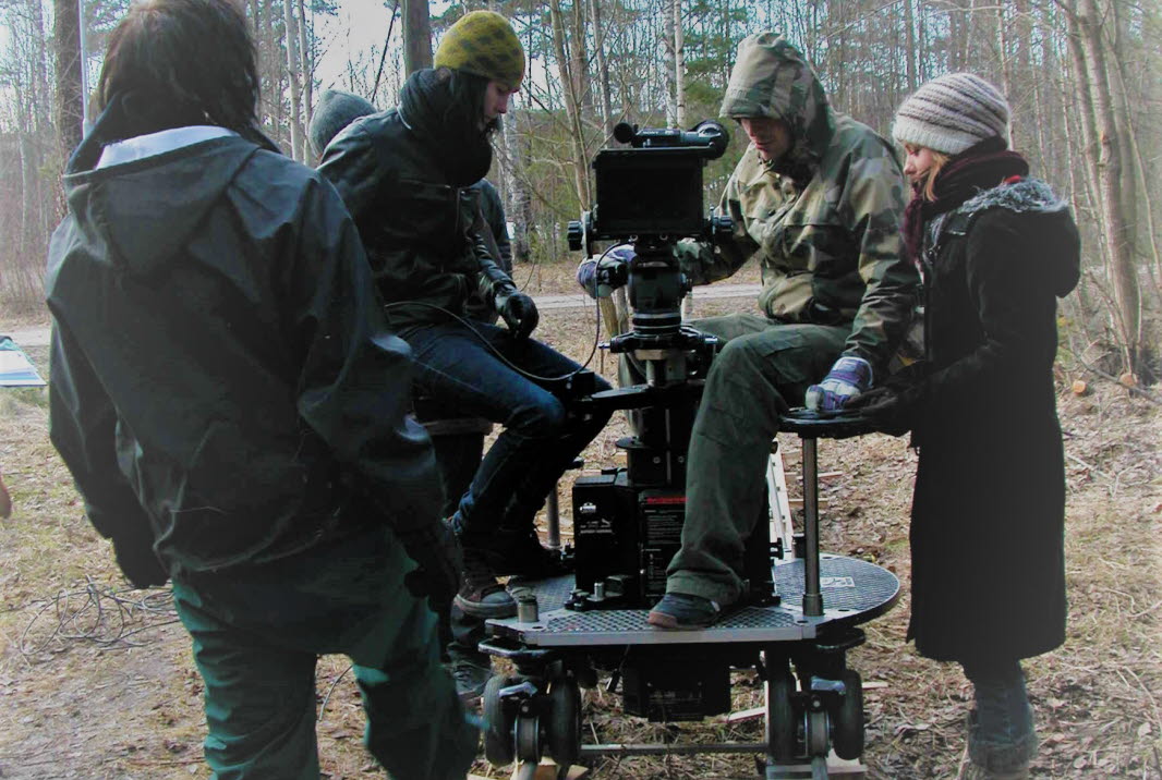 Media students in the woods filming with a big camera