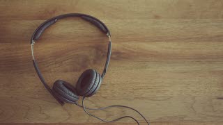 Headphones laying on top of a wooden surface.